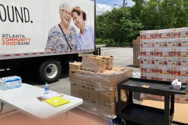 Atlanta Community Food Bank truck parked next to pallets of boxes.
