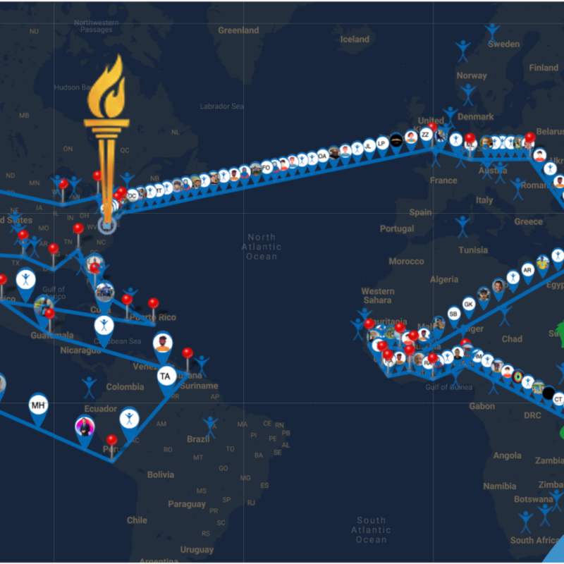 A map of the world with a line for a route and pins to denote places. A drawing of a torch is showing on Virginia United States followed by small icons of people participating along the route.