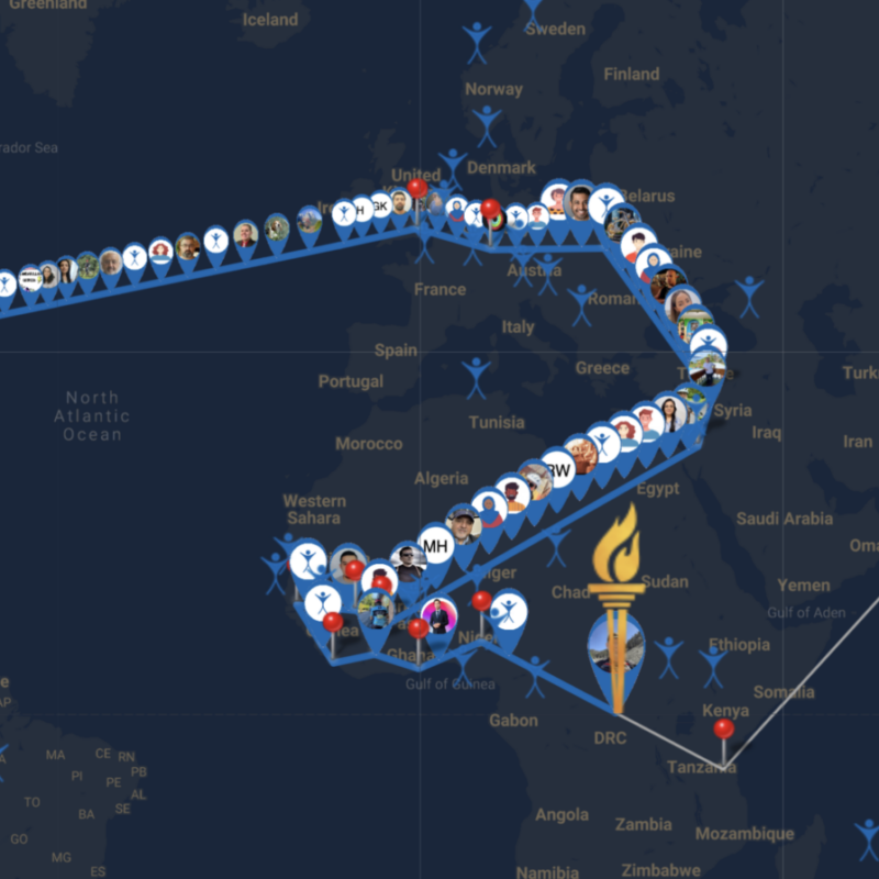 A map showing the United States Europe and Africa with a line for a route and pins to denote places. A drawing of a torch is showing on in the middle of the African continent followed by small icons of people participating along the route.