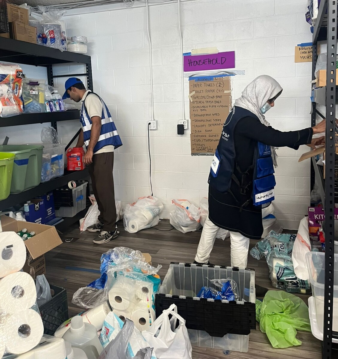 A woman packs household supplies into bags.