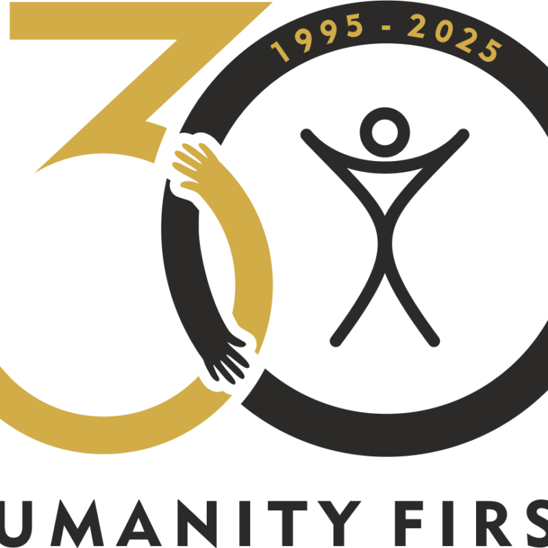 A logo of the number 30 where the curves of the 3 and 0 intersect they look like arms giving each other a hug. The text reads Humanity First 1995-2025.