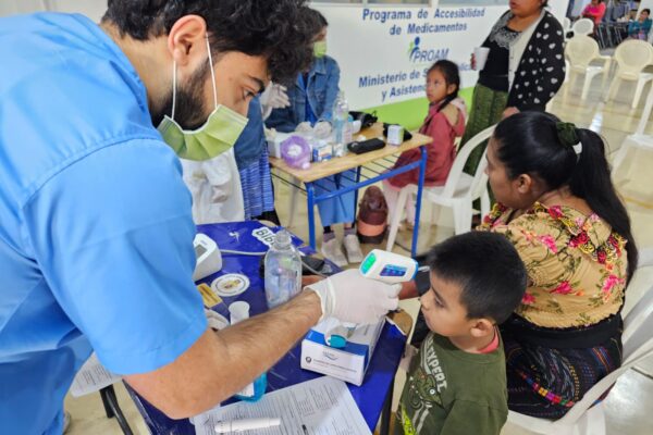 GoH Guatemala UMich Dec 2023 Xenacoj student taking temp of child