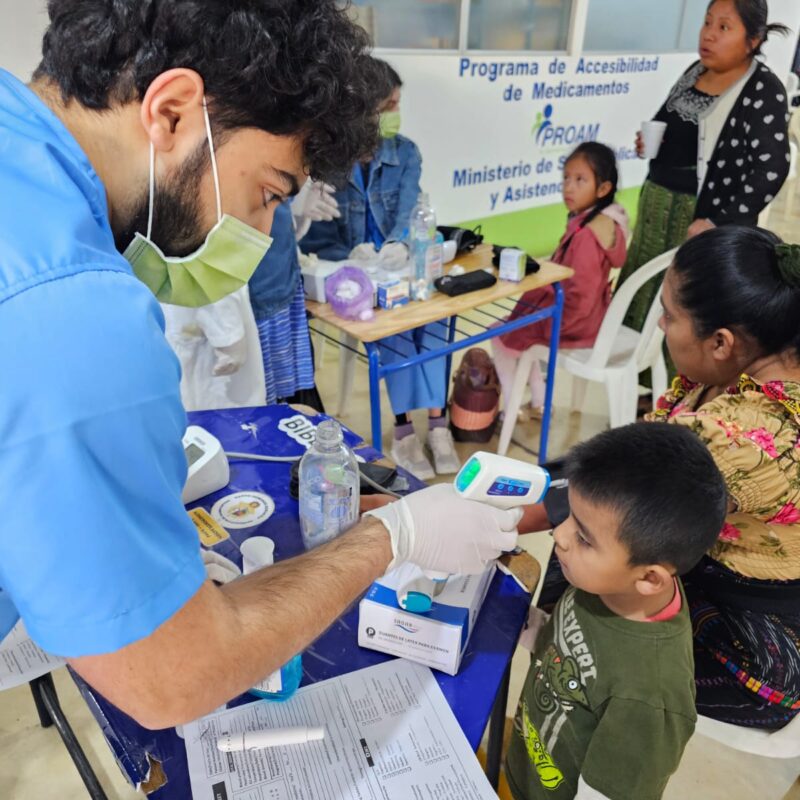 GoH Guatemala UMich Dec 2023 Xenacoj student taking temp of child