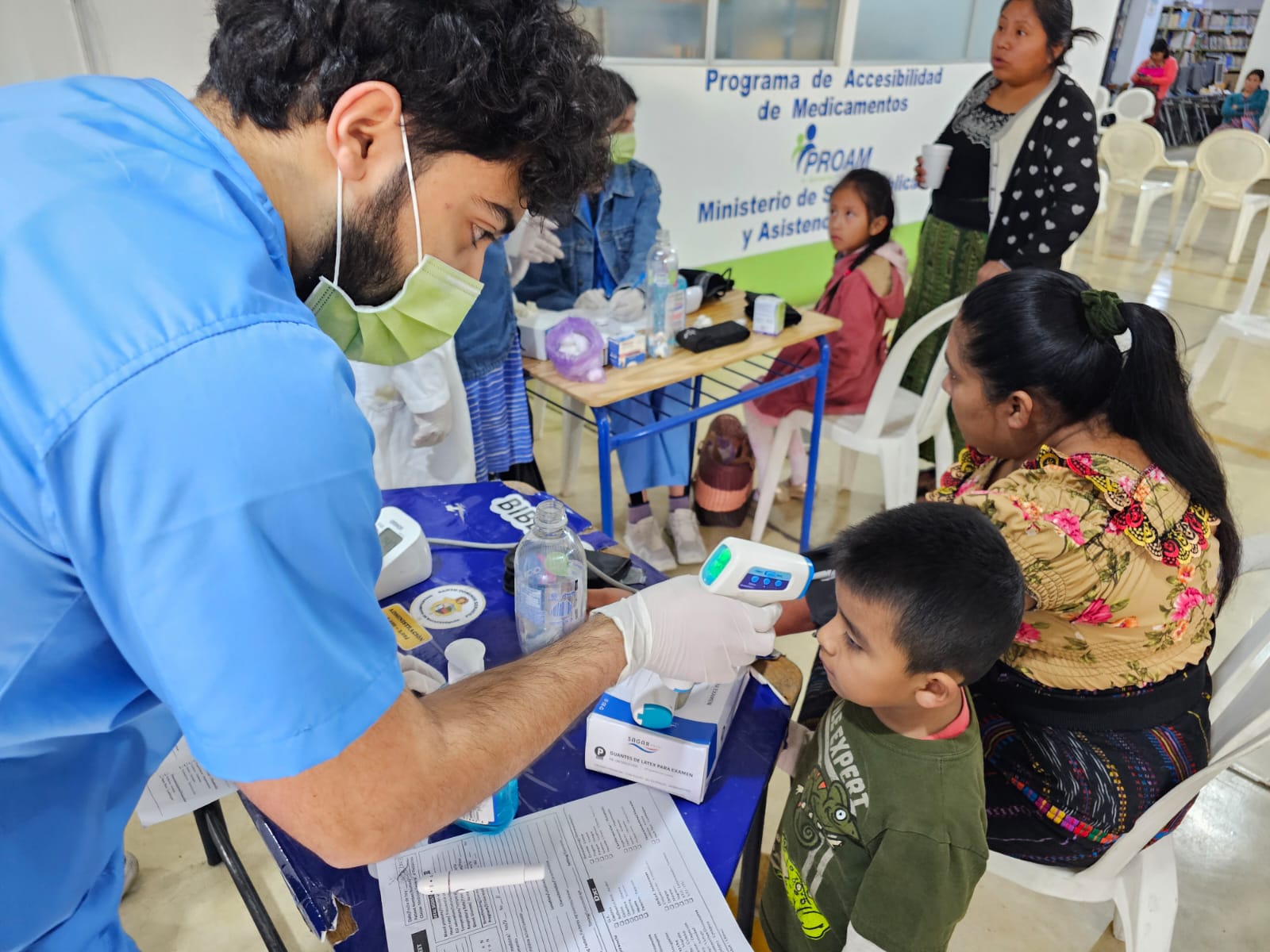 GoH Guatemala UMich Dec 2023 Xenacoj student taking temp of child