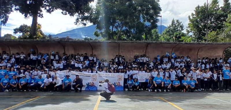 For Walk Run Bike 2025 students at the Humanity First Masroor Ahmed School in Guatemala take a full school picture on the outdoor basketball court.